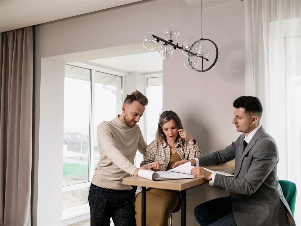 Couple reviewing documents with a signing agent