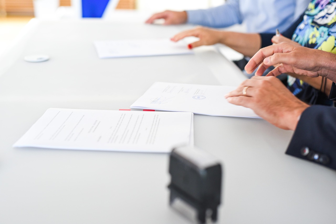 Signing table with documents and a notary stamp