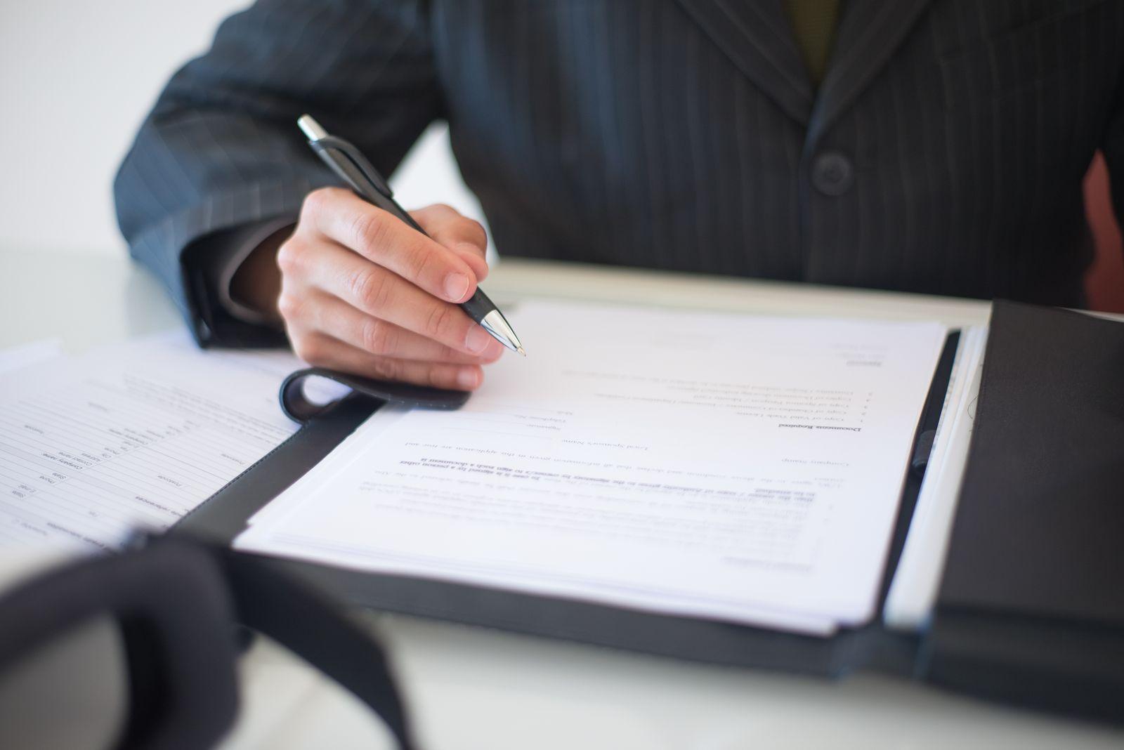 Professional reviewing and signing paperwork