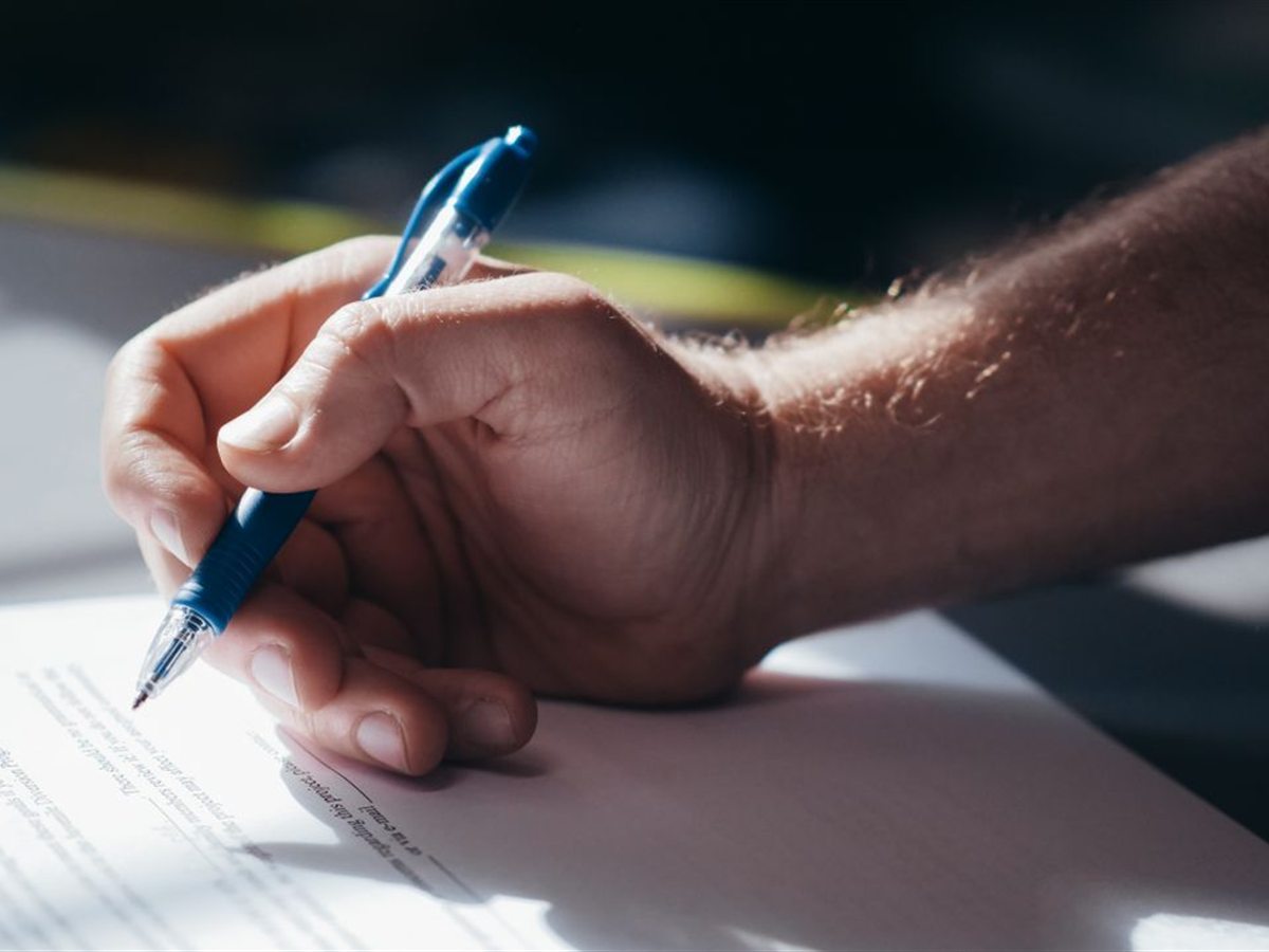 Hand signing a document